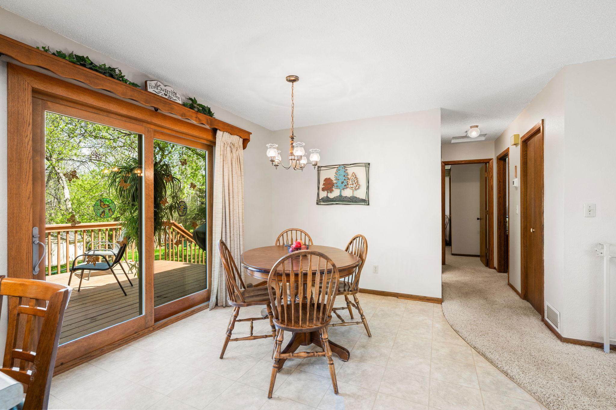 Step out from the dining room onto a private deck with breathtaking backyard views