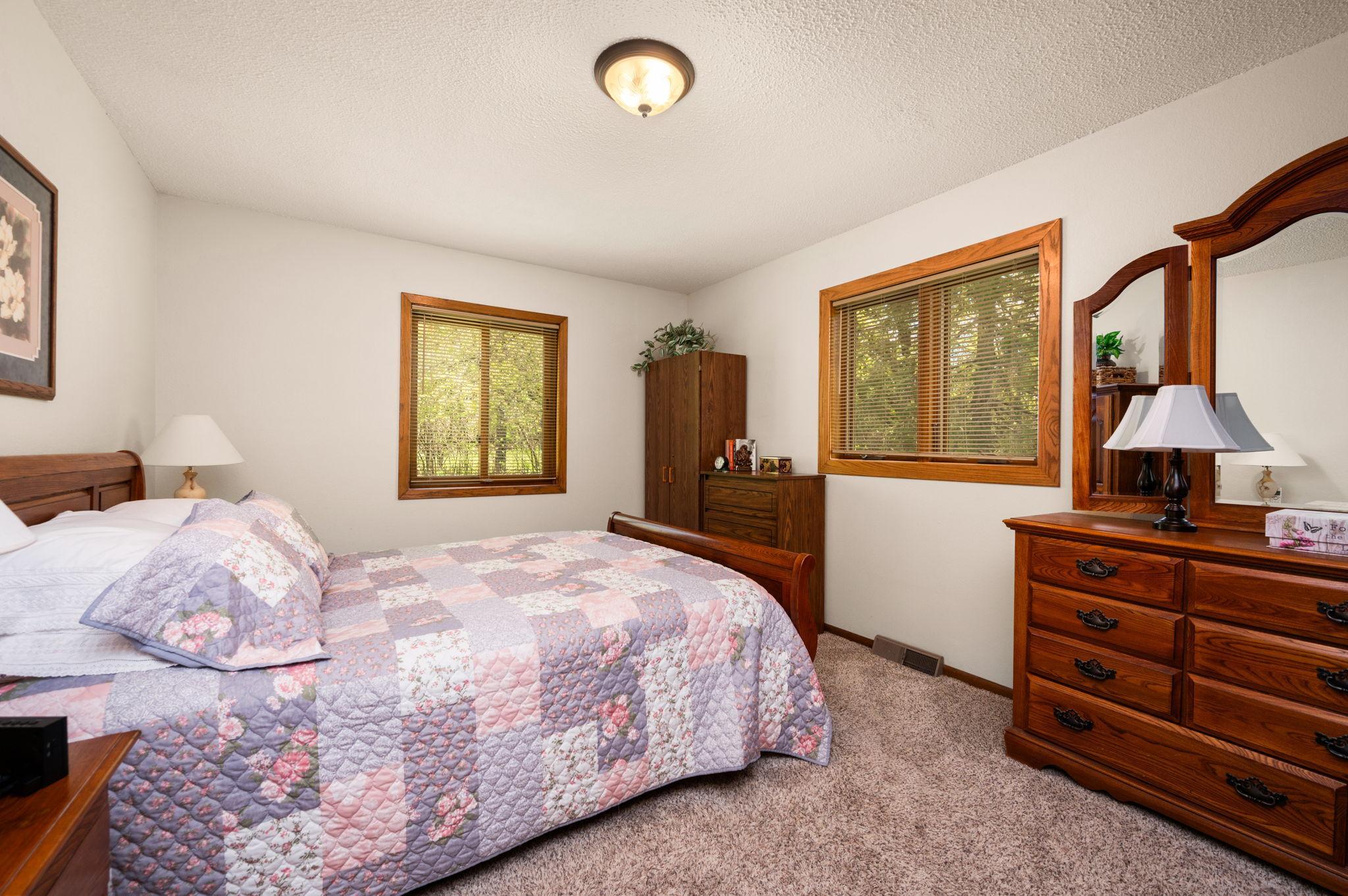 Primary bedroom complete with a walk-in closet