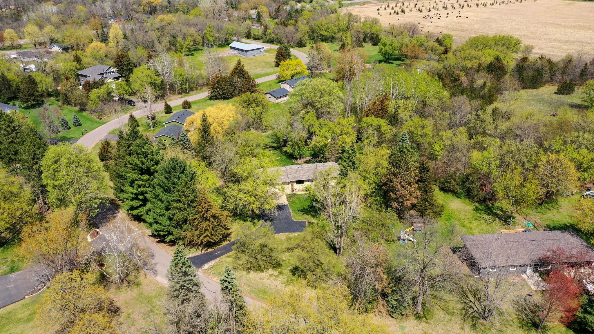 Welcome to your private wooded retreat in this meticulously maintained walkout rambler, perfectly nestled on a stunning, 1+ acre heavily wooded lot