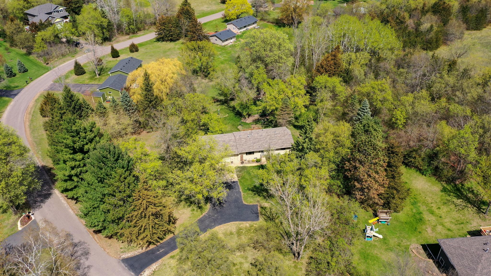 Welcome to your private wooded retreat in this meticulously maintained walkout rambler, perfectly nestled on a stunning, 1+ acre heavily wooded lot