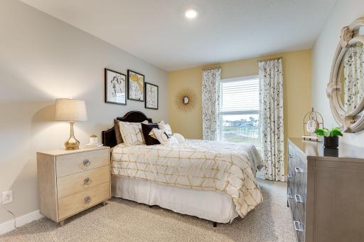 In addition to the primary bedroom, the home's upper level also includes these two additional bedrooms, and another full bathroom just adjacent to each! Photo of model, colors and options will vary.