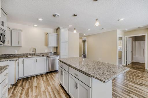 2nd unit kitchen with lots of cabinets, center island, granite counter tops and recessed lighting