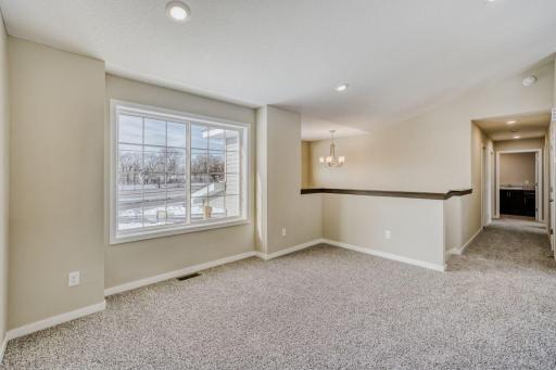 Primary home living room flooded with light and vaulted ceilings