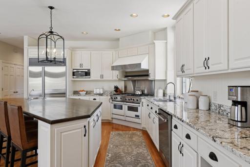 Granite counters top the lower cabinets along the perimeter wall.