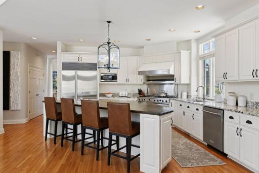 The Kitchen is anchored by a large wood-topped island and Viking range.