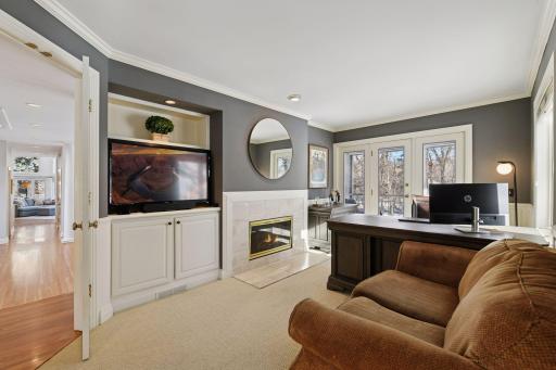 An Office/Den is also situated on the main floor, next to the Great Room. Through the glass door at the rear of the photo is a private screened porch, accessible only via the Office/Den.
