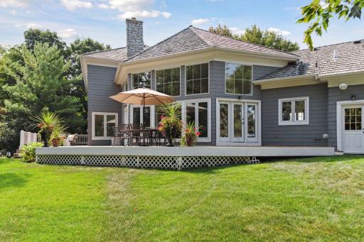 The main floor Family Room/Kitchen features two sets of doors that walk out to the deck. The single door to the far right provides access to the insulated & heated garage.