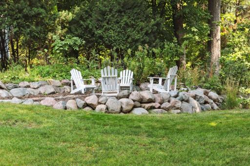The back yard also features a sunken fire pit. An ornamental steel fence was added in 2025 to enclose the rear yard (not shown).