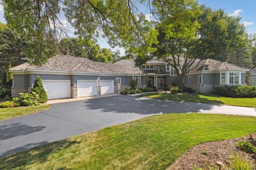 The sprawling, modified 2-story home features 4 bedrooms, each with an en suite bath, and abundant natural light.