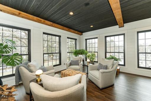 Show stopping sunroom surrounded by windows