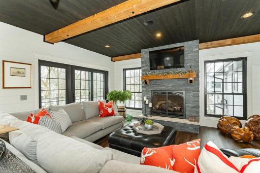 Show stopping sunroom with gorgeous stone surround fireplace