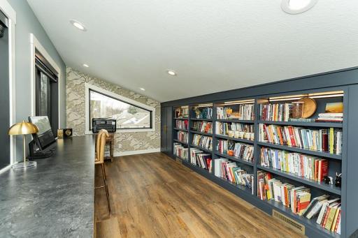 Loft area with built bookshelves w/LED lighting and hidden storage