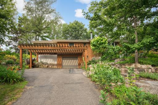Pergola covered driveway and room for 1 or 2 off street parking plus 1 car garage.