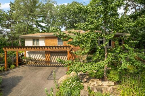 Brick and stucco rambler nestled on a private setting.