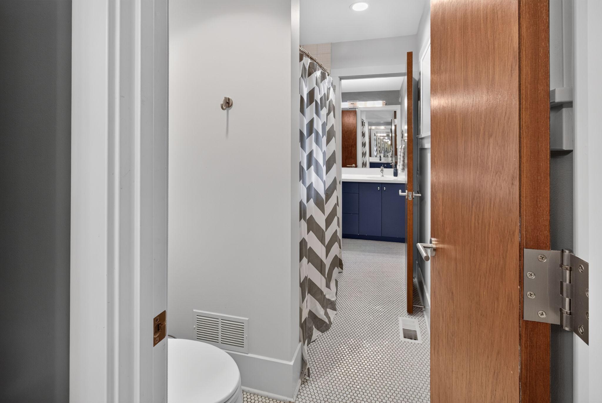 Bath/shower room shared by the 2 attached vanity rooms