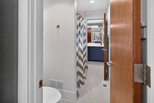Bath/shower room shared by the 2 attached vanity rooms