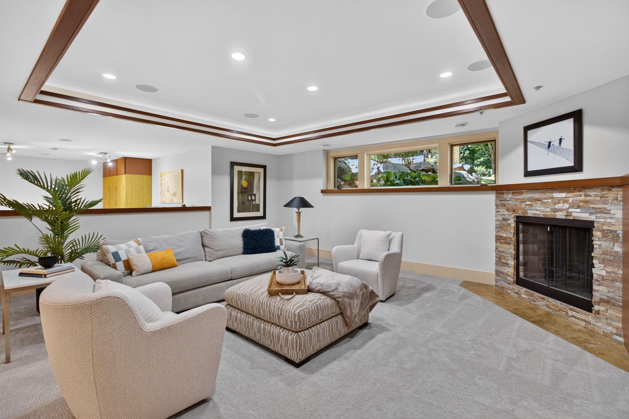 Cozy lower level family room with fireplace and ceiling details