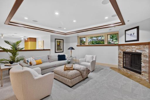 Cozy lower level family room with fireplace and ceiling details