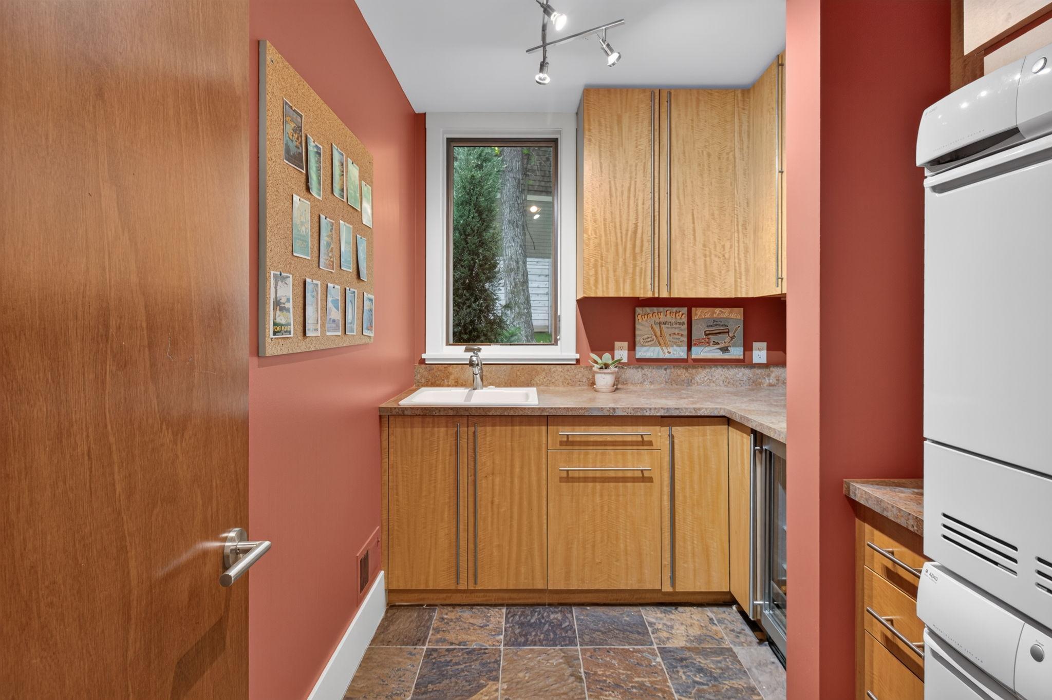 Main level laundry room with sink