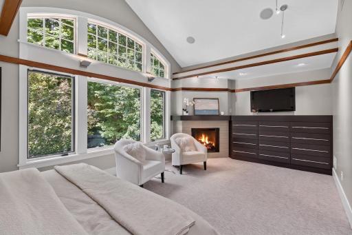 Primary bedroom with fireplace and custom built ins