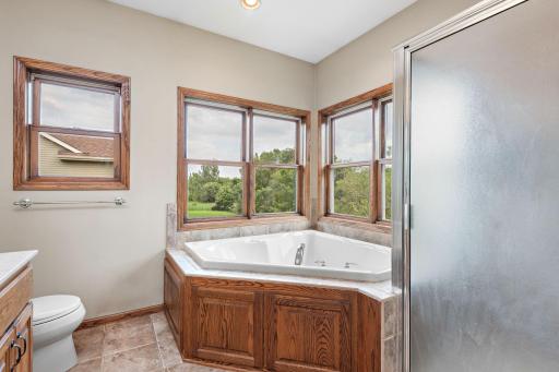 Primary/Owners bathroom with River Views, double vanity, separate jetted tub and shower and tile surround!