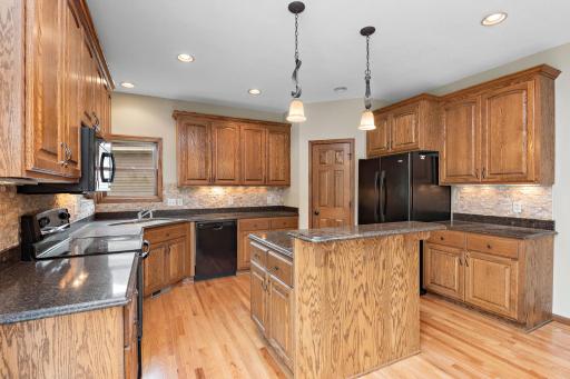 Kitchen has Cambria countertops, breakfast bar, center island, tile backsplash, walk-in pantry and pull-out drawers!