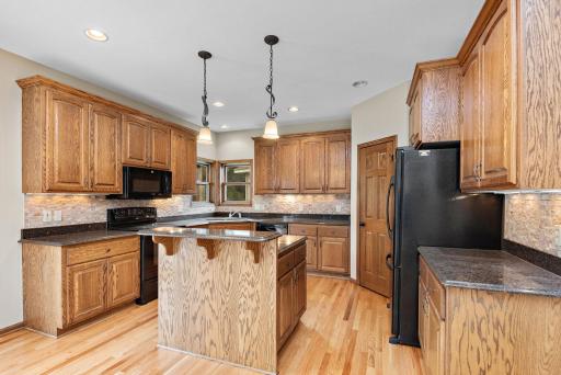 Kitchen has Cambria countertops, breakfast bar, center island, tile backsplash, walk-in pantry and pull-out drawers!