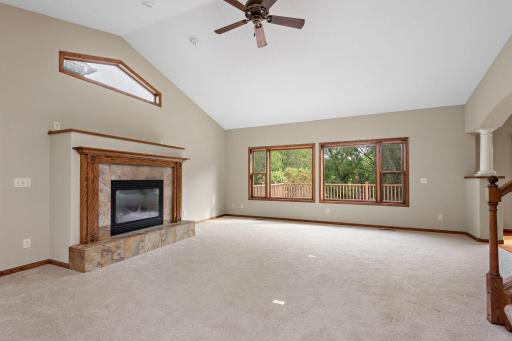 Large main level Living Room with vaulted ceilings, new carpet, ceiling fan and lots of windows to enjoy the river views - OPEN FLOOR PLAN