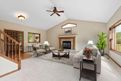 Large main level Living Room with vaulted ceilings, new carpet, ceiling fan and lots of windows to enjoy the river views - OPEN FLOOR PLAN (Virtually Staged)