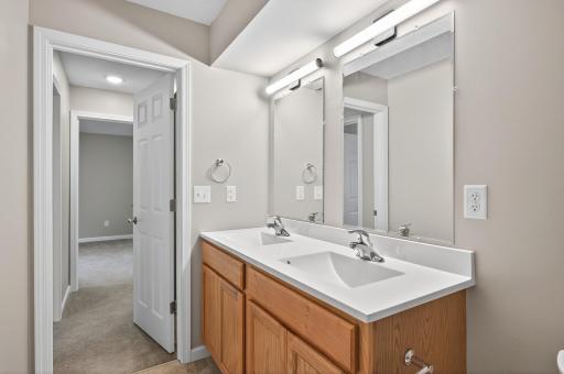 Another view of the bathroom with hallway storage closet on the other side of the door