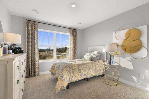 Two secondary bedrooms ideal for guests, office, or hobbies. Model photos. Options and colors may vary.