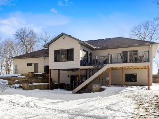 Rear view of house with 4 season porch, deck and patio!