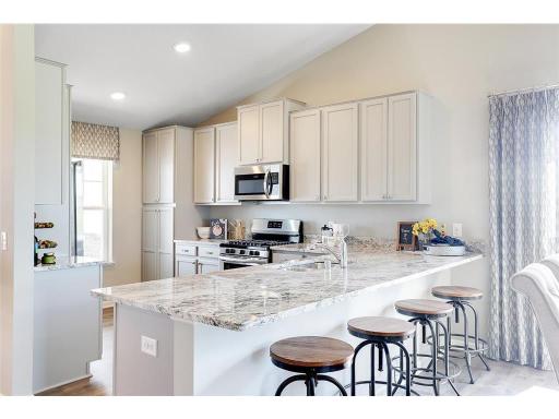 This model features an oversized peninsula in the kitchen. Photo of model home -- finishes in actual home may be different