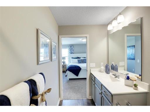 The ensuite bathroom features a double sink vanity
