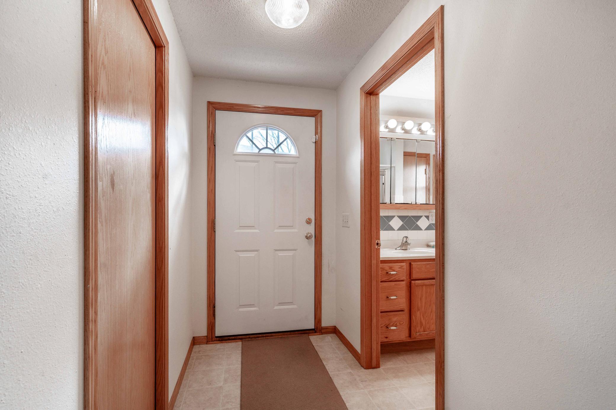 Foyer with the laundry room on the left and the 3/4 bathroom on the right.