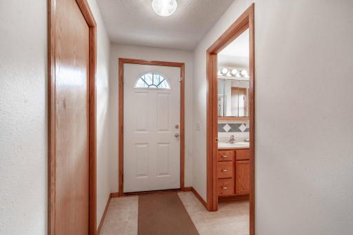 Foyer with the laundry room on the left and the 3/4 bathroom on the right.