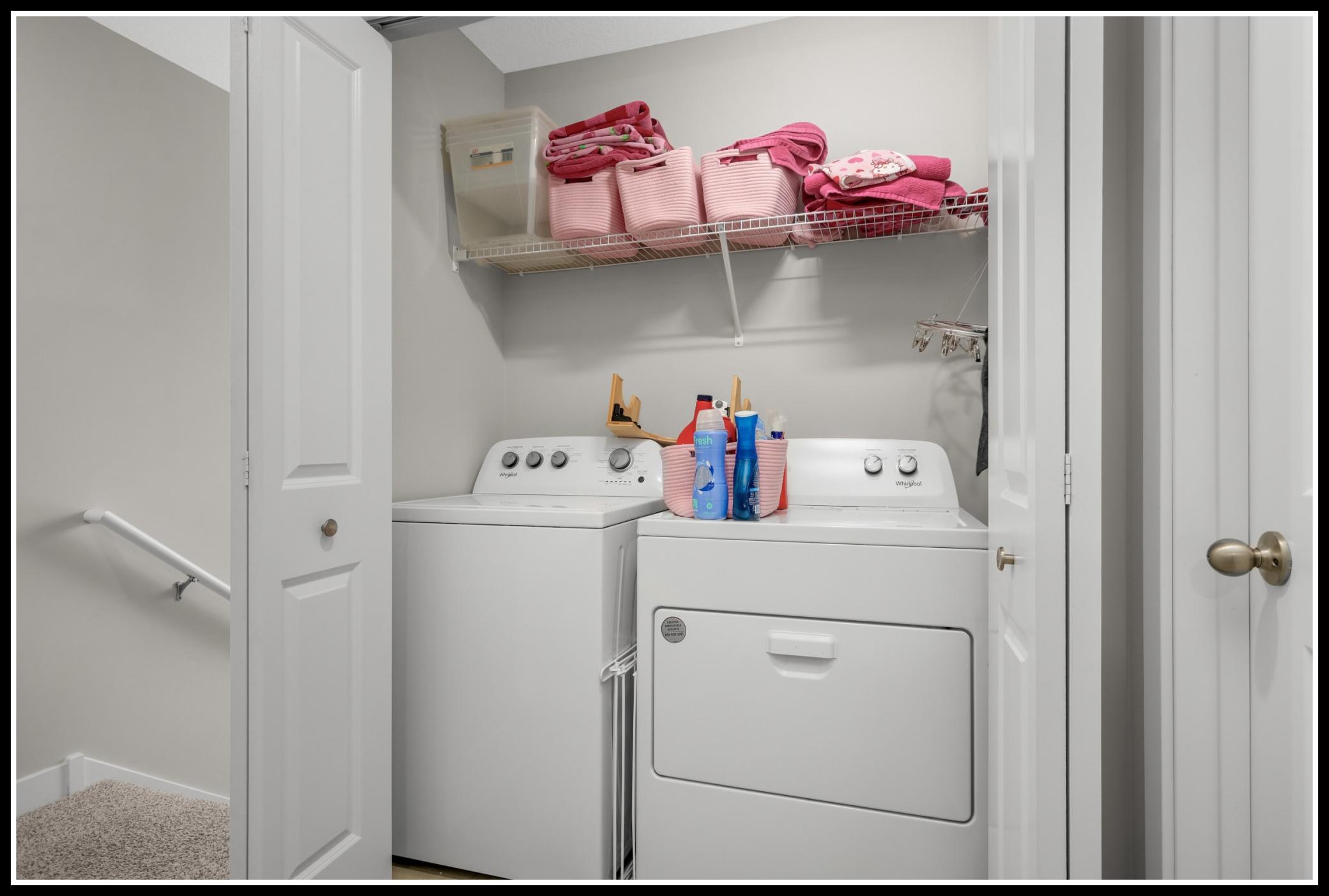 Laundry is conveniently tucked in a closet in the upper level hallway