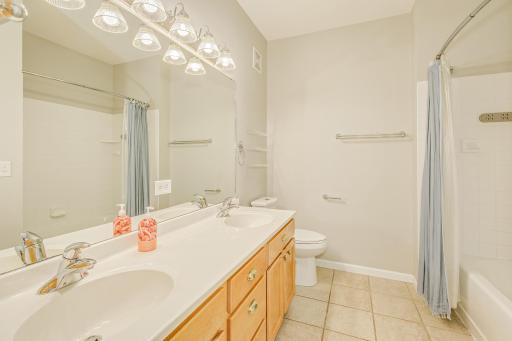 Upper level full bathroom with double sinks.