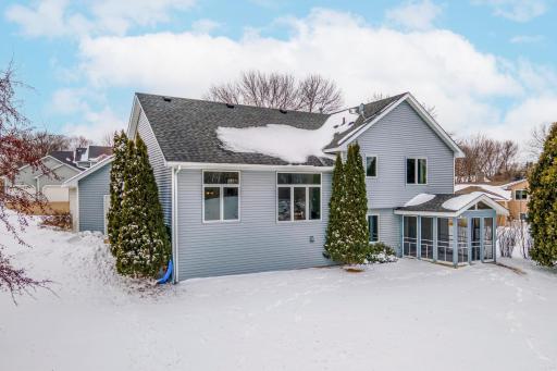 Expansive backyard offering plenty of open space for outdoor activities, highlighted by a screened porch ideal for relaxing and enjoying the surroundings.