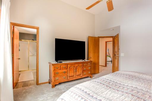Private primary suite with convenient access to an ensuite bathroom, offering both comfort and functionality.