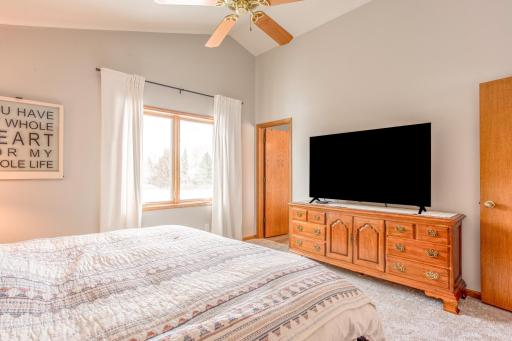 Bright and airy primary bedroom with large windows and plenty of wall space for additional storage or dÃ©cor.