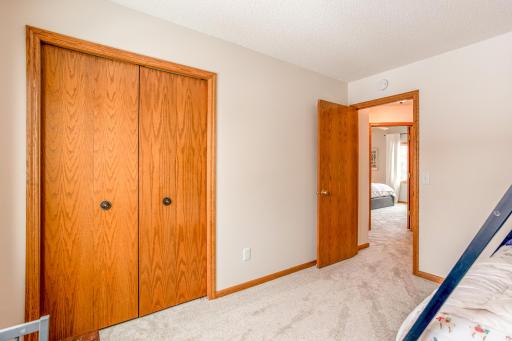 Bright bedroom with ample closet space and room for personalization.