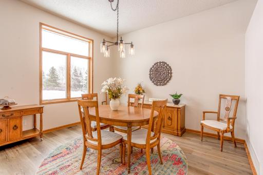 Dedicated dining space with stylish lighting and ample room for gatherings, enhanced by natural light from oversized windows.