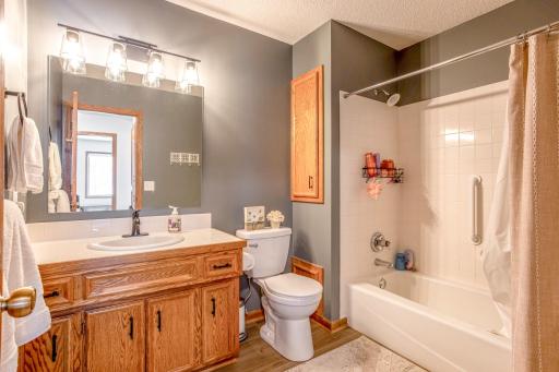 Full bathroom with large vanity, updated lighting, and a tub/shower combination for everyday convenience.