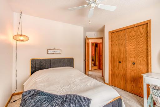 Comfortable bedroom with closet storage and easy access to nearby bathroom amenities.