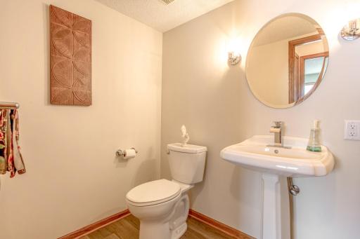 Convenient main-level half bathroom featuring a pedestal sink and clean, functional design.