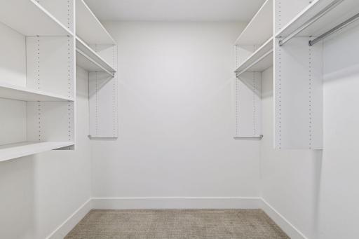 Primary bedroom walk-in closet with organizational compartments.