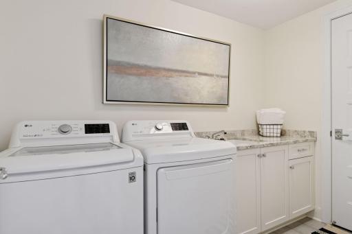 Laundry room with a sink and counter space. This unit also comes with an internal storage room just off the entryway.