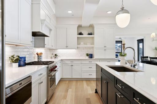 Step into this beautiful Chef's kitchen with Cambria countertops, high-end SS appliances, and lots of counter space for prepping meals.