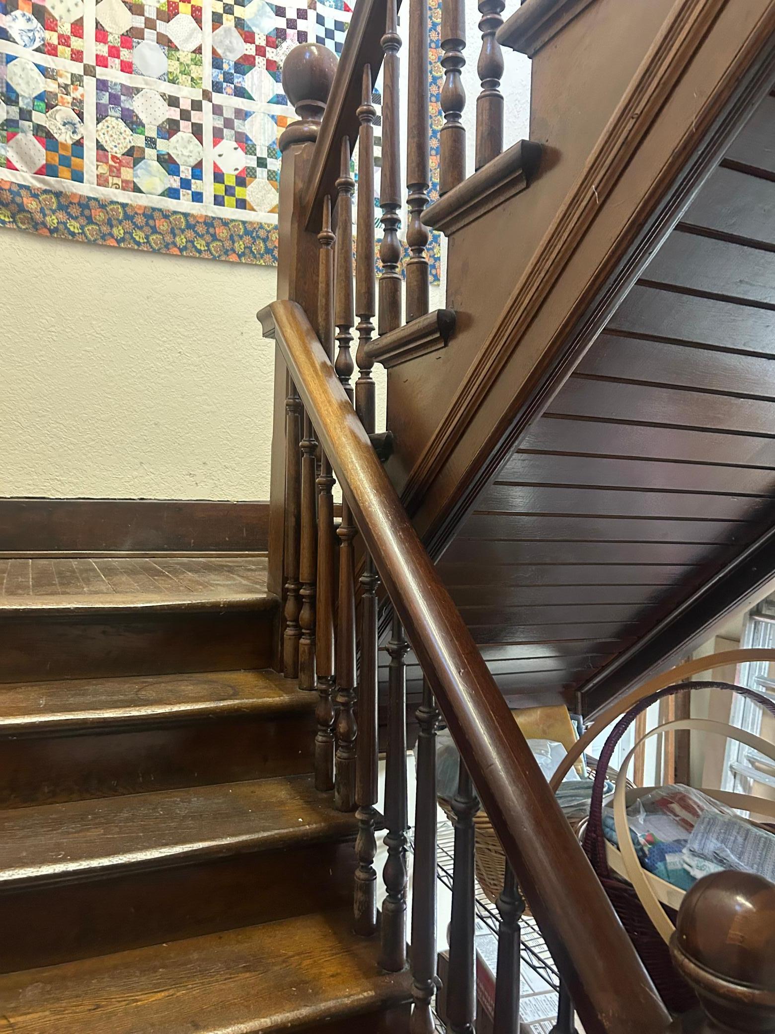 IN back of the main level is a door leading to the basement and this back foyer with steel door to east side of building for exit. Also solid stairwell leading up to 2nd level.